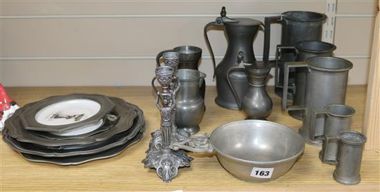 A quantity of pewter including four French porcelain plaques with pewter surrounds